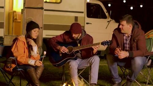 Friends Camping, Playing Guitar at Night