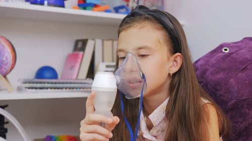 Girl Using Nebulizer for Respiratory Treatment at Home