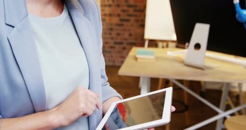 Woman Working on Tablet in Creative Office