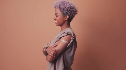 Smiling Woman with Bandage on Arm