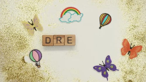 Child Spells Dream with Blocks on Glittery Background