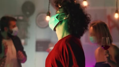 People Dancing With Face Masks at Party