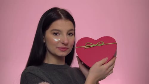 Smiling Teen with Heart Shaped Gift Box