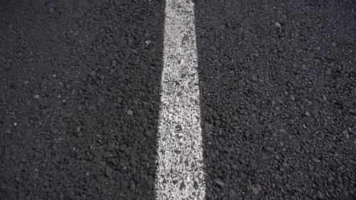Man Walking Along Empty Road Towards Mist