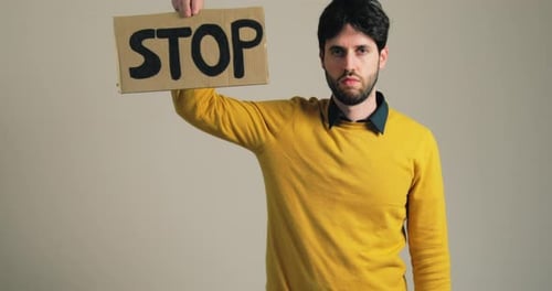 Boy in Yellow Shirt Holds Stop War Billboard in Hand
