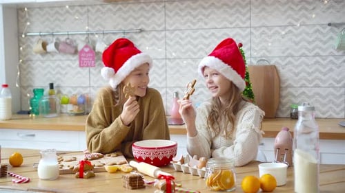 Girls Baking Gingerbread Cookies in Festive Kitchen