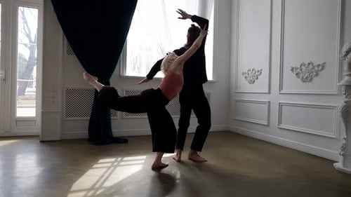 Beautiful Young Woman is Dancing with Her Partner Rehearsing Dance in Training Hall
