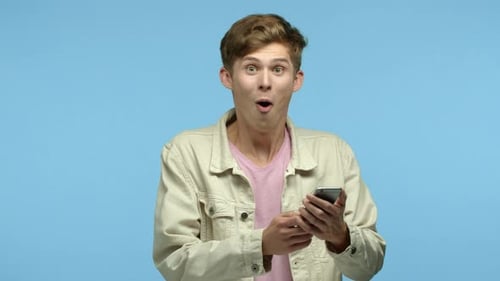 Excited Young Man Checks Phone