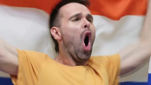 Man Cheers Holding Flag Close Up