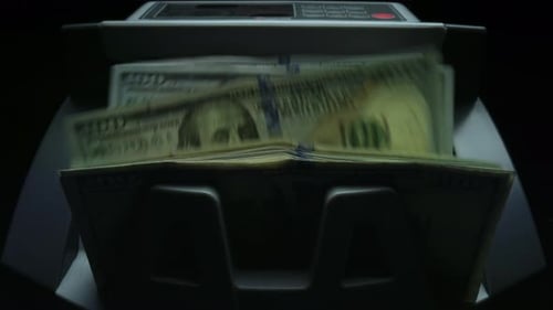 Currency Counting Machine Processing Hundred Dollar Bills