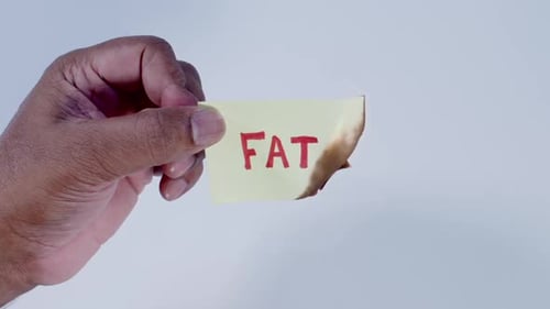 Hand Holding Burn Fat on Paper Note
