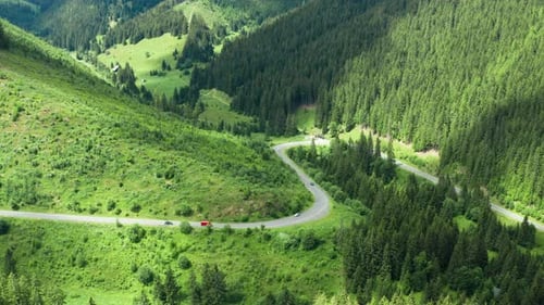 Aerial View of Landscape Serpentine Road with Moving Cars Winding on the Mountains