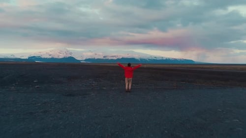 Man on rocky ground in mountains jumping