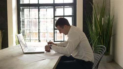 the manager works at the table opposite the window