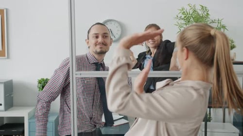 Enthusiastic Employees Dancing in Modern Office