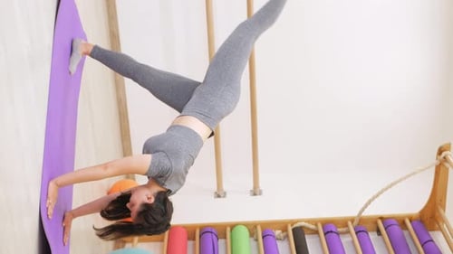 Young Woman is Doing Gymnastics in Gym
