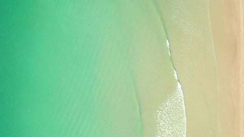 4K Aerial view top view of drone, sea waves and beautiful sand beach.