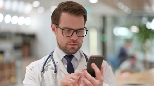 Male Doctor Using Smartphone Indoors