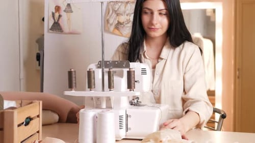 Black Haired Seamstress in Atelier Portrait at Work