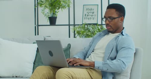 Young Adult Working on Laptop at Home
