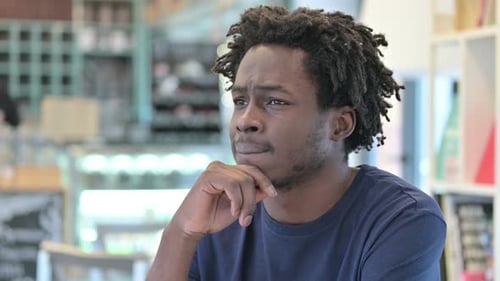 Man Thinking Closely Indoors in a Workplace