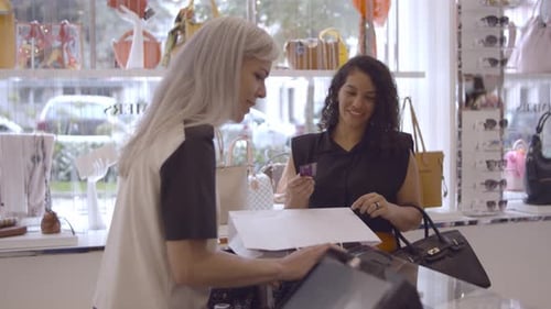 Woman Paying with Credit Card at Shop Counter