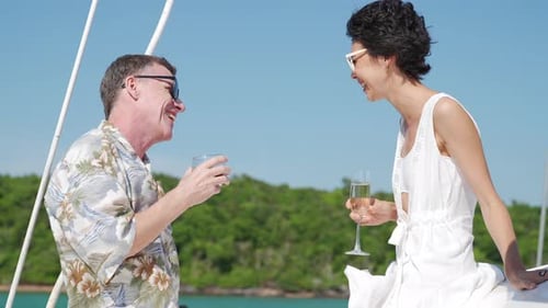 Smiling Couple Toasting Drinks on a Boat