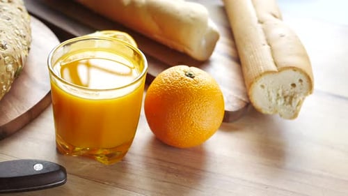 Orange Juice, Bread, and Orange for Breakfast