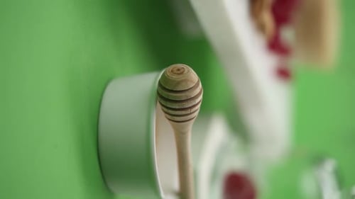 Close Up of Honey Dipper and Raspberries