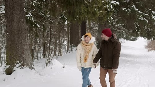 Multiethnic Couple Walking in Winter Forest