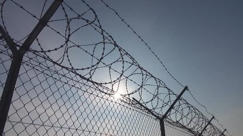 Barbed Wire Fence Security Against Blue Sky