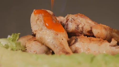 Sauce Being Drizzled Over Cooked Chicken Drumsticks