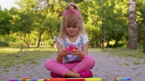 Child Girl Kid Playing Squeezing Antistress Pop It Touch Screen Toys Simple Dimple Game in Park