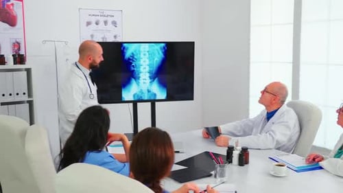 Medical Professionals Discussing X-Ray in Office