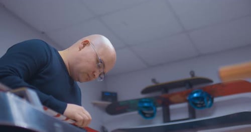 Male Master Works in a Workshop for the Repair of Sports Equipment and Equipment