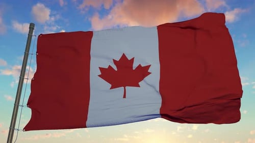 Canadian Flag Waves Against Sky at Sunrise