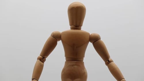 Wood mannequin over white background rotating. Close up