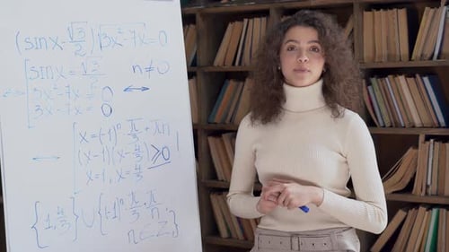 Hispanic School Teacher Giving Math Class Looking at Camera Explaining Equation