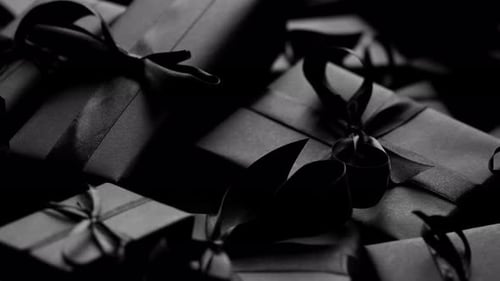 Elegant Gifts Wrapped in Dark Paper and Ribbons