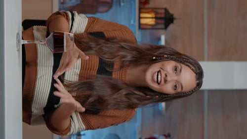 Woman Video Conferencing and Drinking Wine Indoors