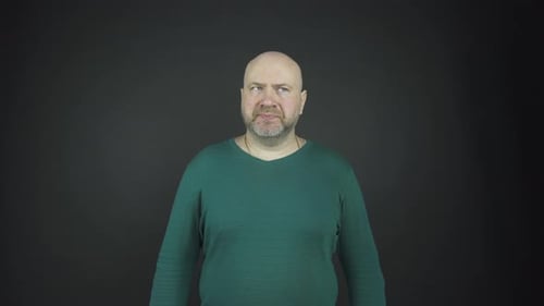 Bald Man with Beard Looking at Camera