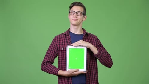 Young Adult Holding Tablet with Green Screen