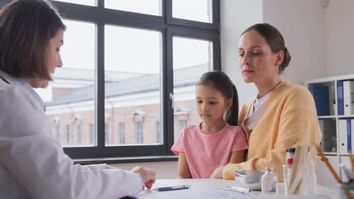 Mother with Little Daughter and Doctor at Clinic