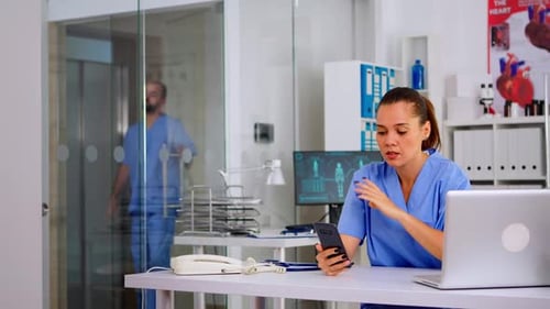 Medical Professional On Cell Phone in Modern Office