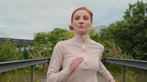 Close-up woman running over bridge