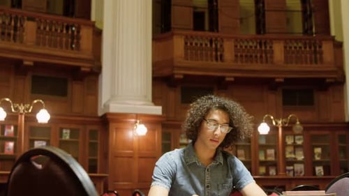 Man studying in the library 4k