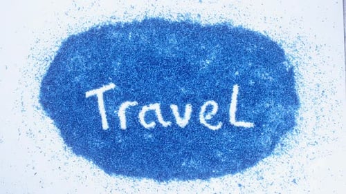Hand Writes Travel on Blue Shavings