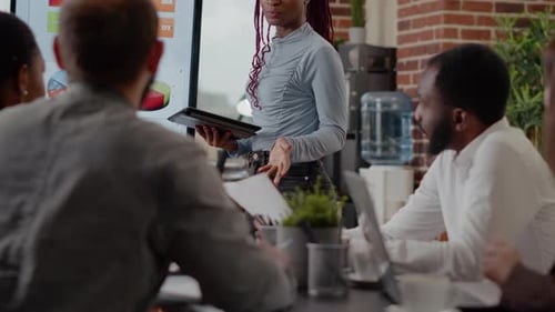 Close Up of Woman Doing Financial Presentation at Briefing Meeting