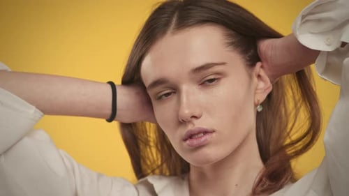 Young Woman Smiling Against Yellow Background