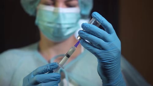 Medical Professional Preparing Injection in Close Up